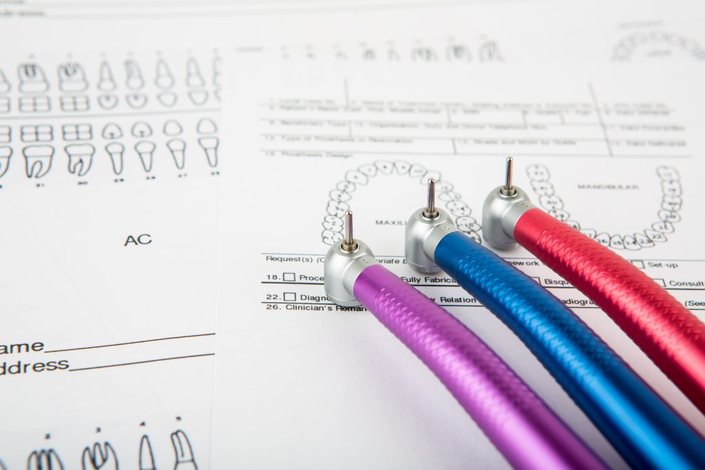 Instrumental y ficha dental sobre la mesa de trabajo